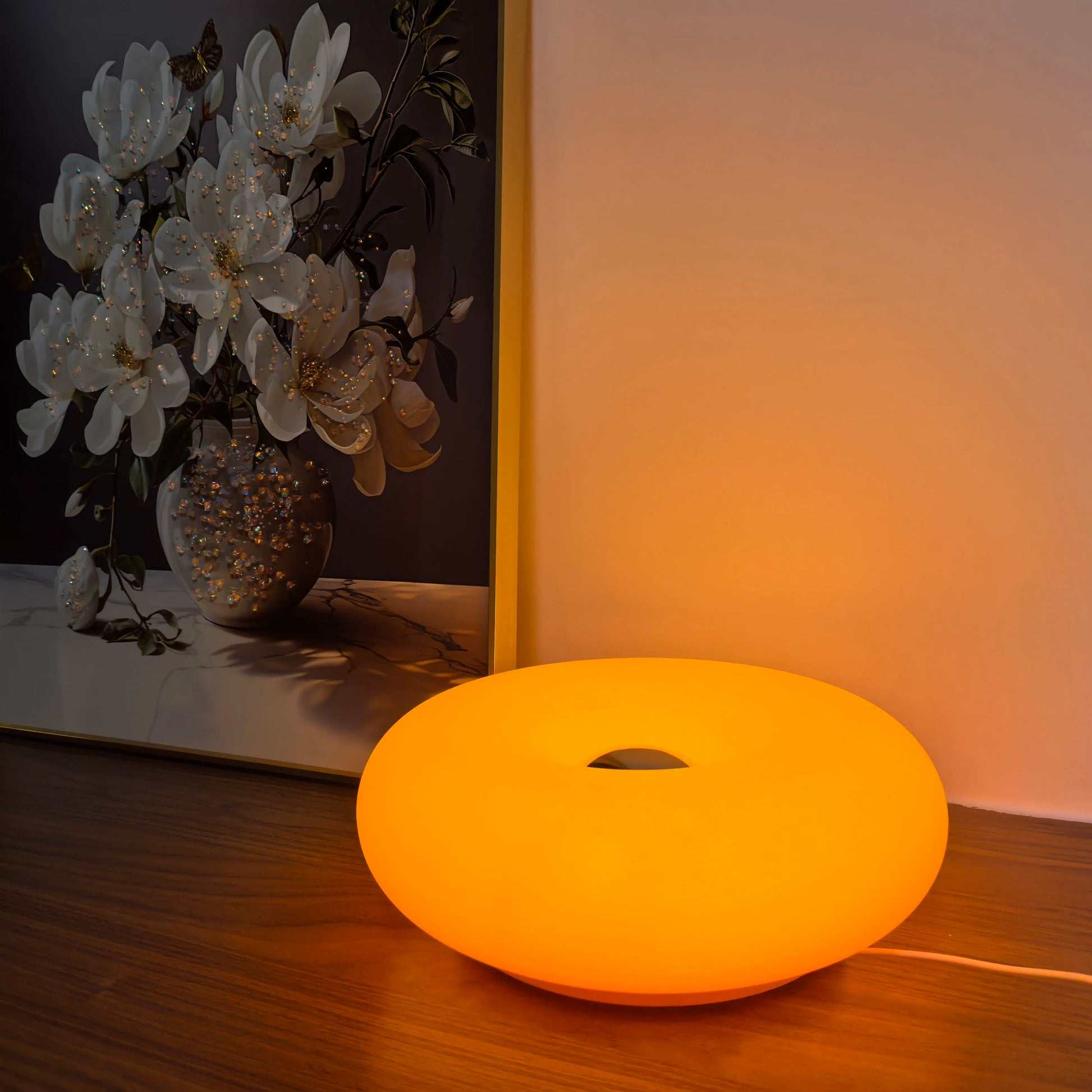Orange LED lamp on a wooden surface with a blurred background