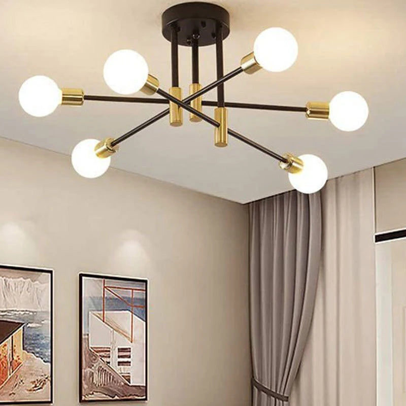 Modern chandelier with six light bulbs in a room with framed pictures on the wall.